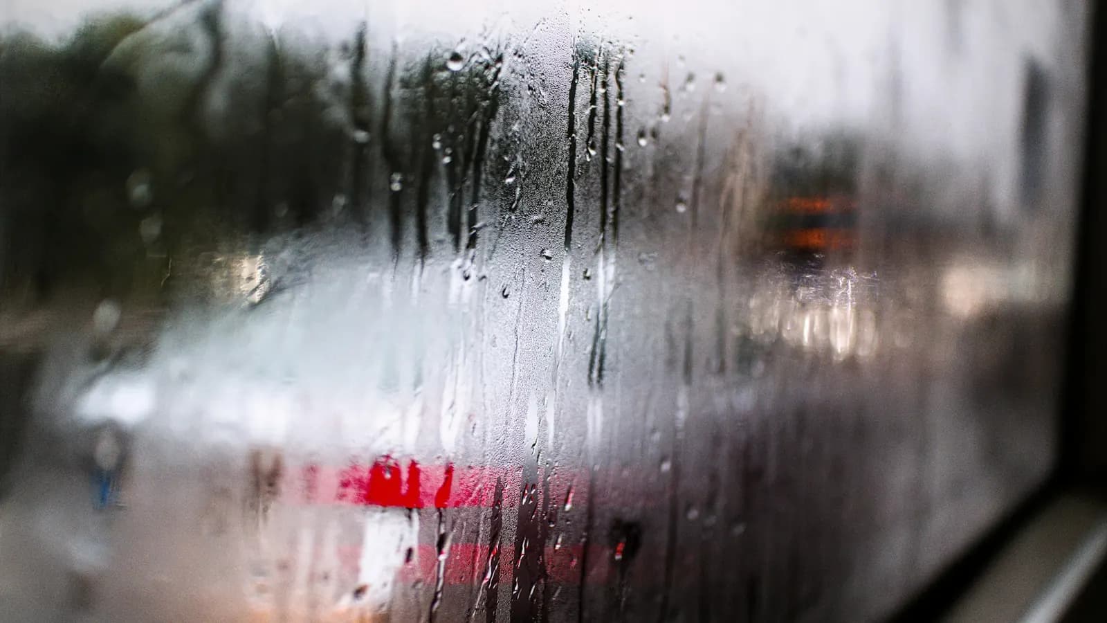 Condensation running down the inside of a misted car window